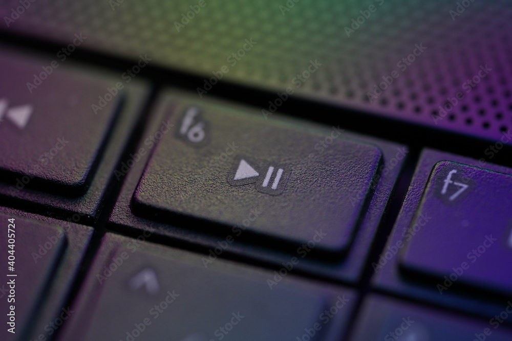 Play Pause symbol button on a laptop keyboard with gradient light. Play Pause symbol button on a laptop keyboard with gradient light.