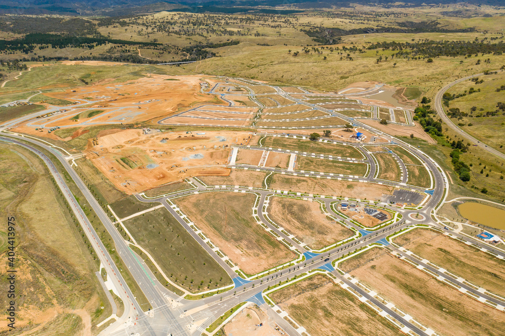 Aerial drone view of new road development and residential construction site in the newly established suburb of Whitlam in Canberra, the capital city of Australia 