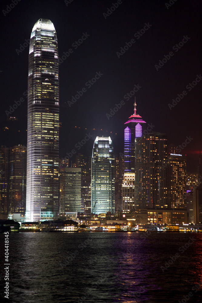 Obraz premium Victoria Harbor Skyline and Two International Finance Center at night in Hong Kong