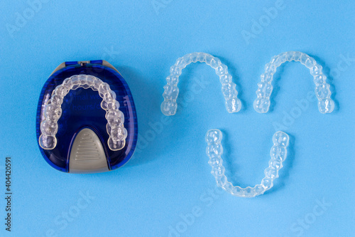Invisalign braces or invisible retainer on blue background