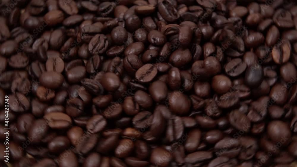 roasted coffee beans, close-up of coffee beans. falling coffee beans selective focus. slow mo roasted coffee beans, close-up of coffee beans. falling coffee beans selective focus. slow mo