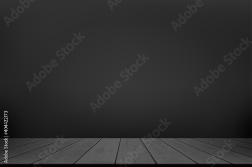 Black wooden table or floor against a dark wall.