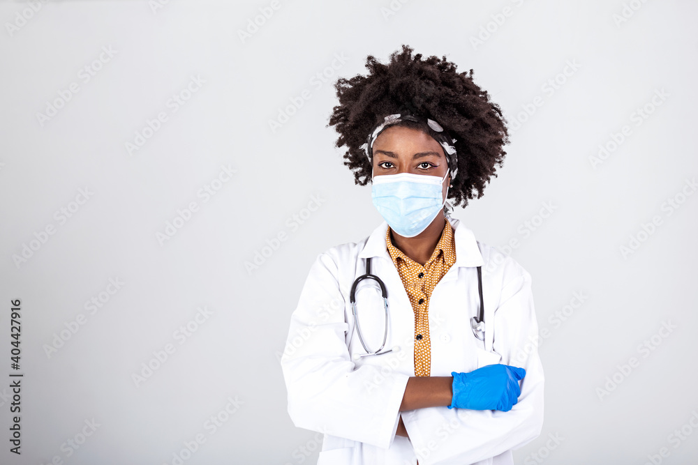 African american female doctor wear white medical coat stethoscope face mask look at camera closeup headshot portrait. Brave proud black hero physician on grey, healthcare safety, medicine protection African american female doctor wear white medical coat stethoscope face mask look at camera closeup headshot portrait. Brave proud black hero physician on grey, healthcare safety, medicine protection