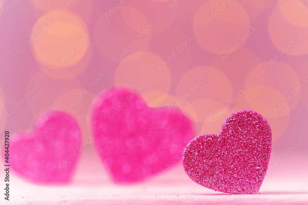 Pink glitter heart decoration on pink background
