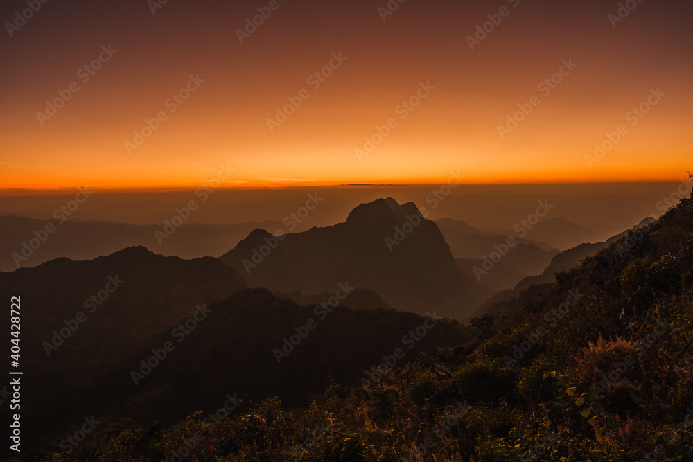 Mountains under mist in the Evening Setting sun beautiful Mountains from Doi Luang Chiang Dao Chiang Mai In Thailand Natural forest