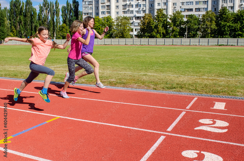 Obraz premium Family fitness, mother and kids running on stadium track, exercise with children and sport healthy lifestyle concept 