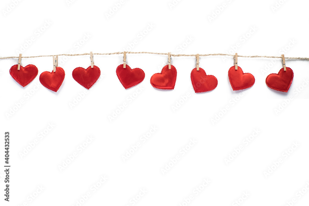 Clothespins and red hearts on a rope isolated on white background. Valentine's Day. Clothespins and red hearts on a rope isolated on white background. Valentine's Day.