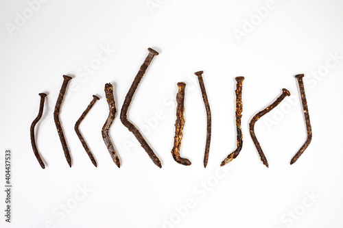 Old rusty nails covered with corrosion on a white background.