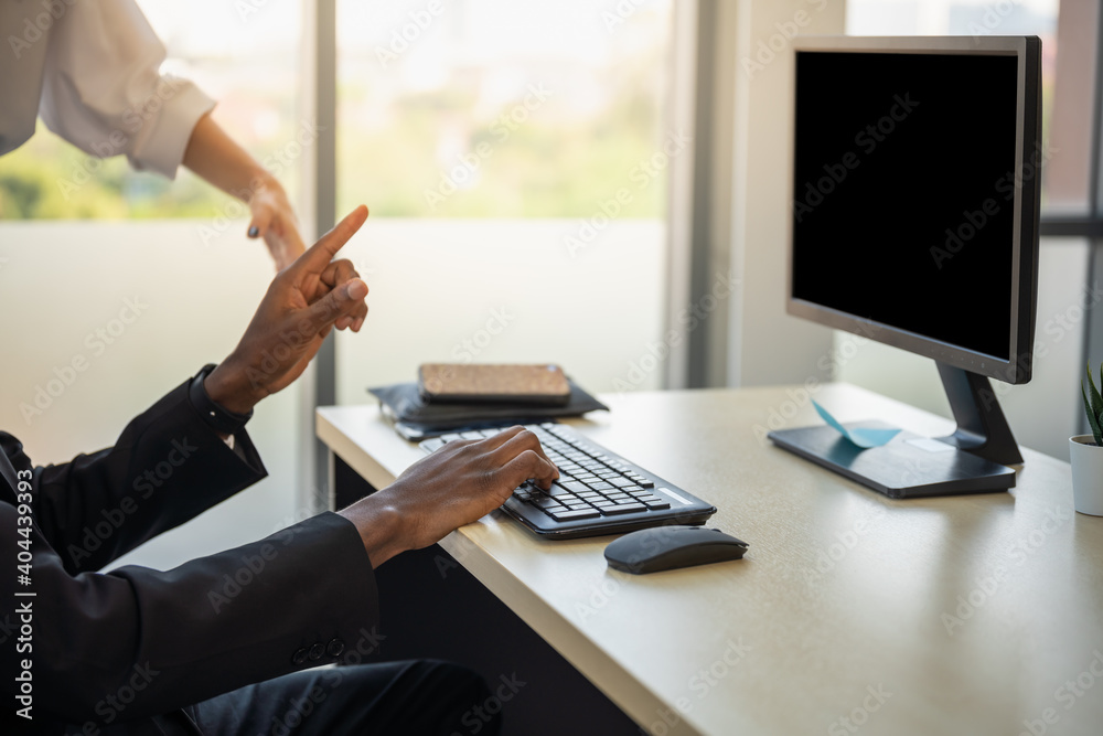 Diversity Business and Work place concept. Closeup of Young African businessman hand working  with computer and keyboard in office.
