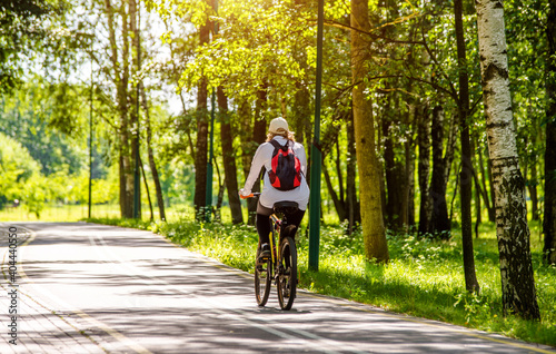 Wallpaper Mural Cyclist ride on the bike path in the city Park
 Torontodigital.ca
