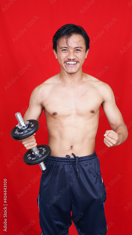 asian man holding barbell isolated red baclground asian man holding barbell isolated red baclground