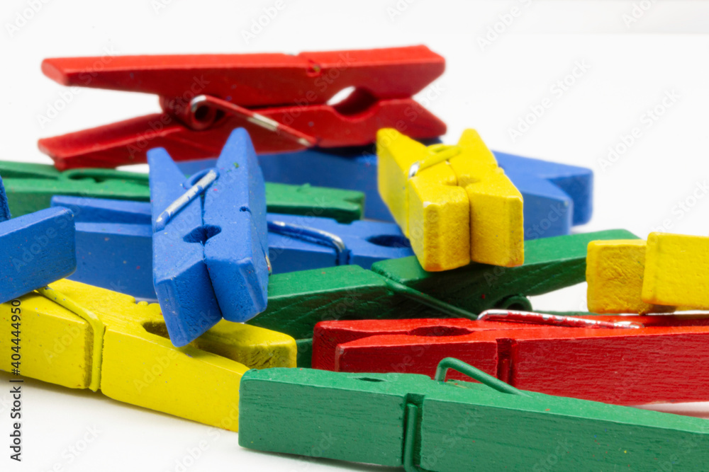 colored pegs on a white background, clothes pegs