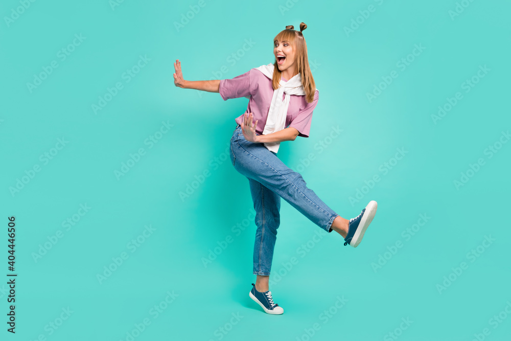 Full size photo of young happy excited smiling girl with jumper on shoulders dancing isolated on turquoise color background