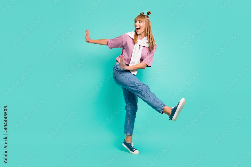 Full size photo of young happy excited smiling girl with jumper on shoulders dancing isolated on turquoise color background Full size photo of young happy excited smiling girl with jumper on shoulders dancing isolated on turquoise color background