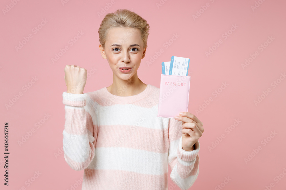 Traveler tourist woman in sweater dental braces hold passport tickets doing winner gesture isolated on pastel pink background Passenger traveling abroad on weekends getaway Air flight journey concept. Traveler tourist woman in sweater dental braces hold passport tickets doing winner gesture isolated on pastel pink background Passenger traveling abroad on weekends getaway Air flight journey concept.