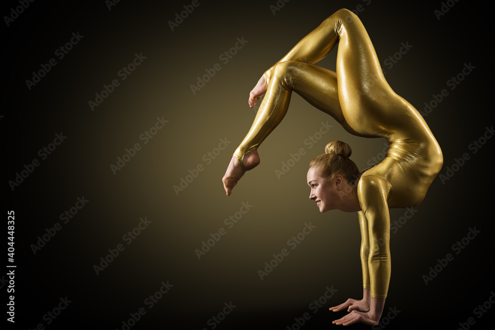 Flexible Woman Gymnast doing Yoga Stretching Pose. Standing on hands Back bending. Gold perfect strong healthy Acrobat Body. Over Black