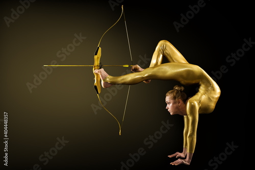 Obraz na plátně Archer Shooting by Legs with Gold Bow and Arrow