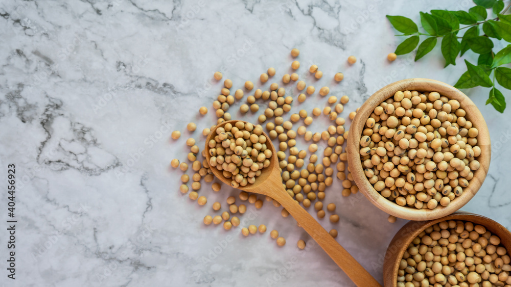 soybeans in wooden bowl with wooden spoon on the table.