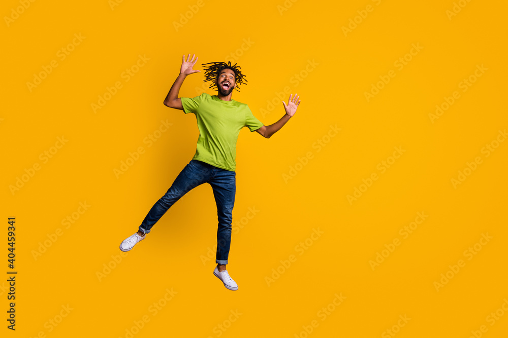 Photo portrait full body view of man jumping up next to blank space isolated on vivid yellow colored background