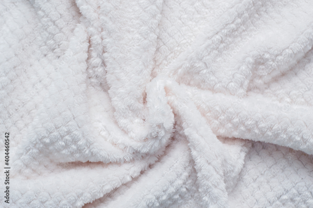 Plaid white fluffy. Texture of a fluffy white microfiber plaid. Warm fabric background. Plaid white fluffy. Texture of a fluffy white microfiber plaid. Warm fabric background.