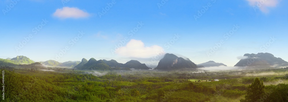 Panorama view of mountains landscape with fog on blue sky and clouds background in Phatthalung province, Southern of Thailand Panorama view of mountains landscape with fog on blue sky and clouds background in Phatthalung province, Southern of Thailand