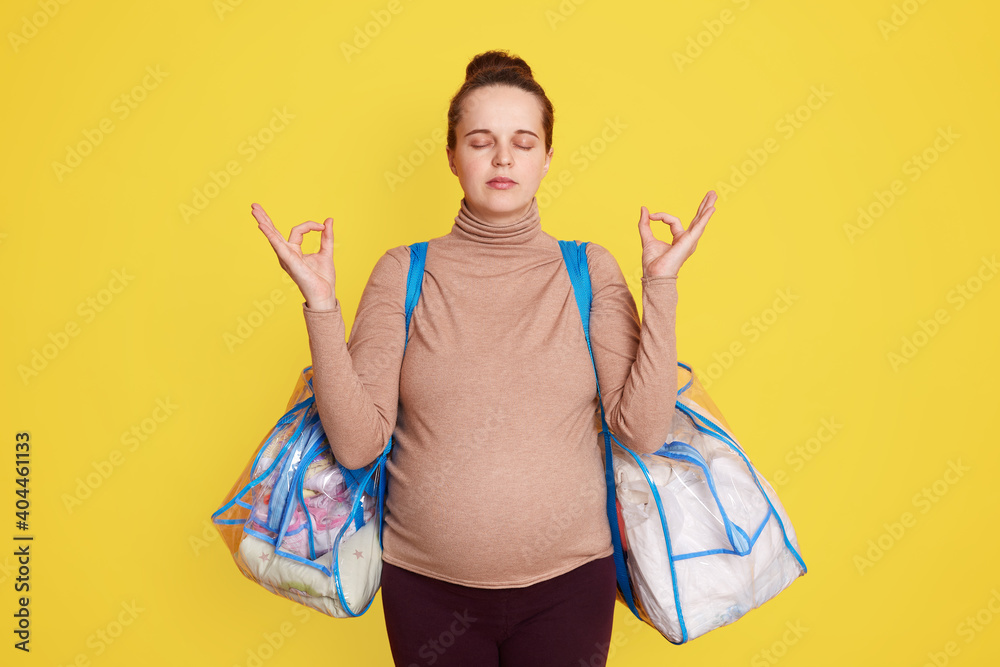 Nice adorable calm lovely beautiful expectant mom wearing casual attire