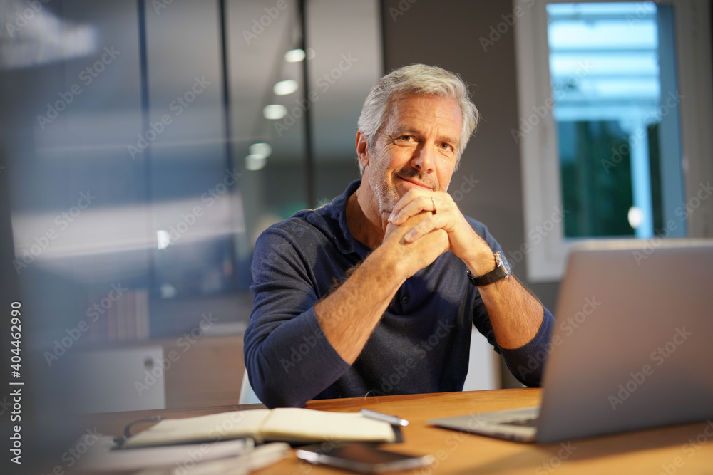 Portrait of senior man with grey hair connected with laptop Portrait of senior man with grey hair connected with laptop