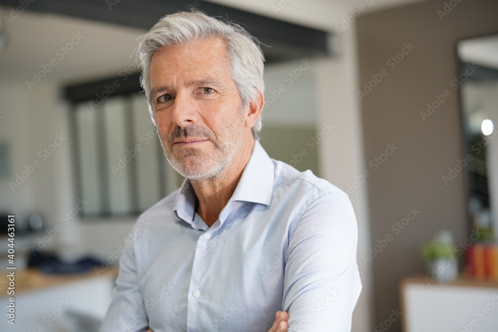 Portrait of senior businessman with arms crossed looking at camera