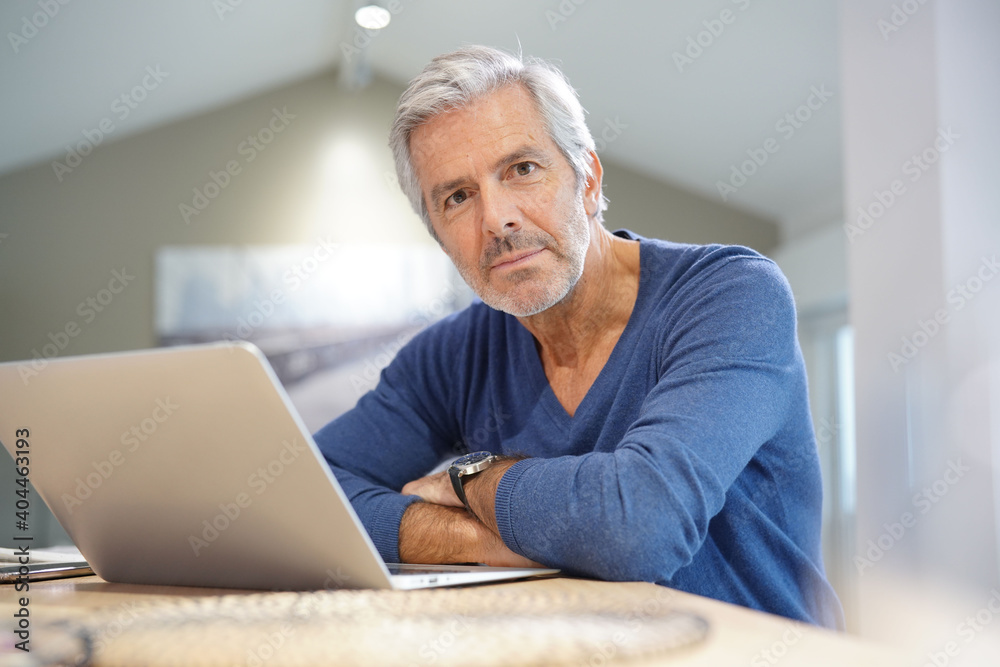 Portrait of senior man at home working on laptop Portrait of senior man at home working on laptop