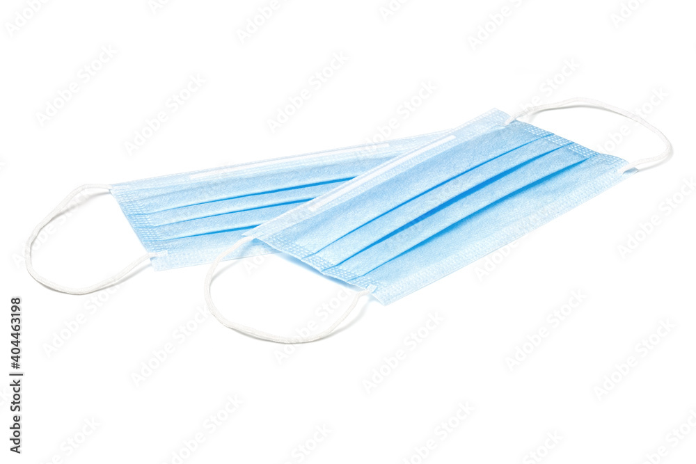Two blue medical face masks isolated on white background. Surgical protective masks close-up. Two blue medical face masks isolated on white background. Surgical protective masks close-up.