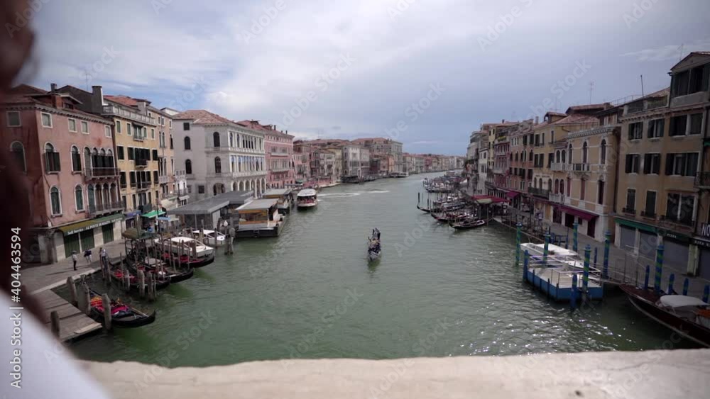 Walking with steadycam steadicam in picturesque bridge on the Grand Canal with traditional colorful houses of Venice town in famous tourist attraction, Italy. Walking with steadycam steadicam in picturesque bridge on the Grand Canal with traditional colorful houses of Venice town in famous tourist attraction, Italy.
