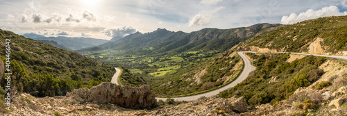Road leading to green valley and mountains in Corsica