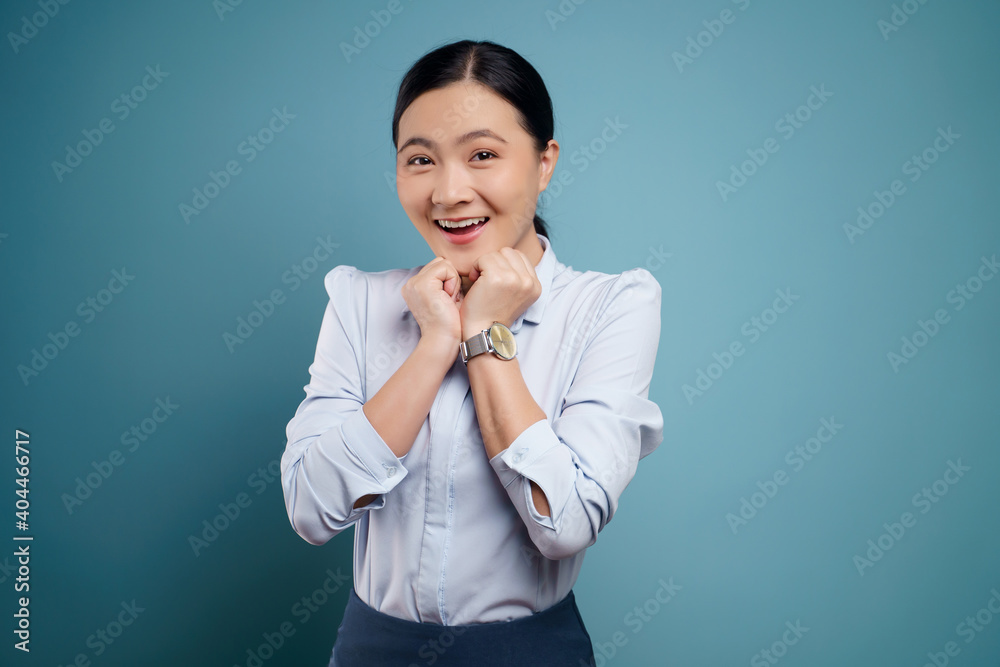 Asian woman happy surprised isolated on blue background. Asian woman happy surprised isolated on blue background.