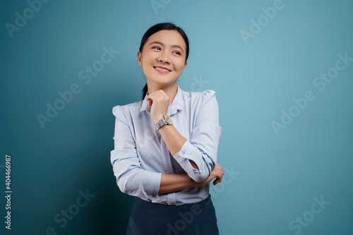 Asian woman happy surprised isolated on blue background.