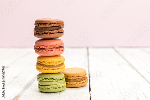Fototapeta Naklejka Na Ścianę i Meble -  Stack of colorful french macarons pastry on rustic white table