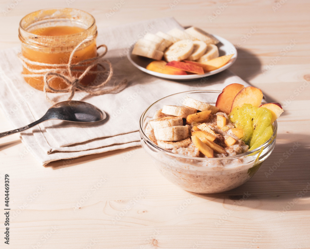 a bowl of morning porridge and fruit as a healthy breakfast concept