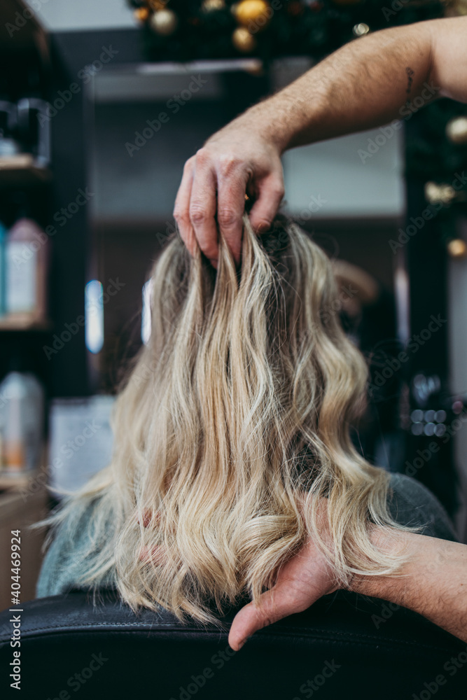 Fototapeta premium Beautiful hairstyle of woman after dyeing hair and making highlights in hair salon.