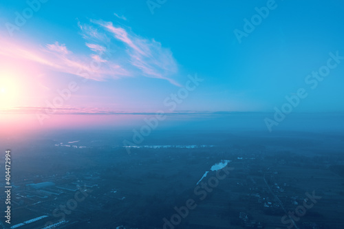 Rural landscape in the morning with the blue-pink sky. Aerial view of the countryside during sunrise © vvvita