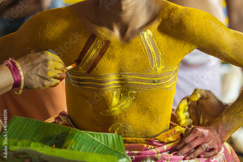 Theyyam artist preparing to perform during temple festival in Payyanur, Kerala, India. photo