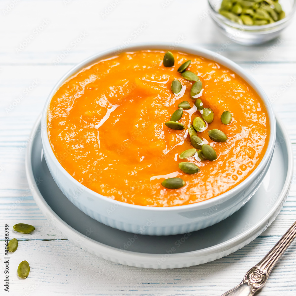 Vegan curried pumpkin lentil soup puree in a bowl. Space for text. Vegan curried pumpkin lentil soup puree in a bowl. Space for text.