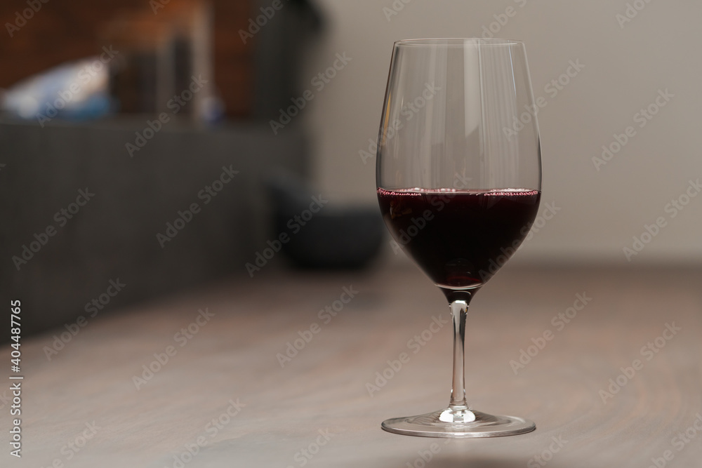 Red wine in thin wine glass on wood table Red wine in thin wine glass on wood table