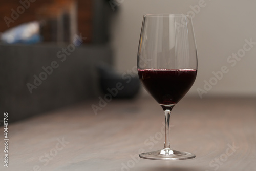 Red wine in thin wine glass on wood table
