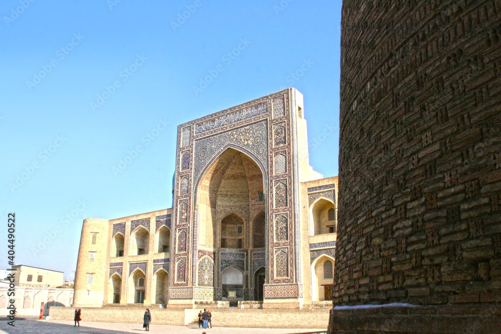 Bukhara, Uzbekistan - November 24 2019 : Poi Kalan or Po-i-Kalyan, an Islamic religious complex located around the Kalan minaret at cold weather