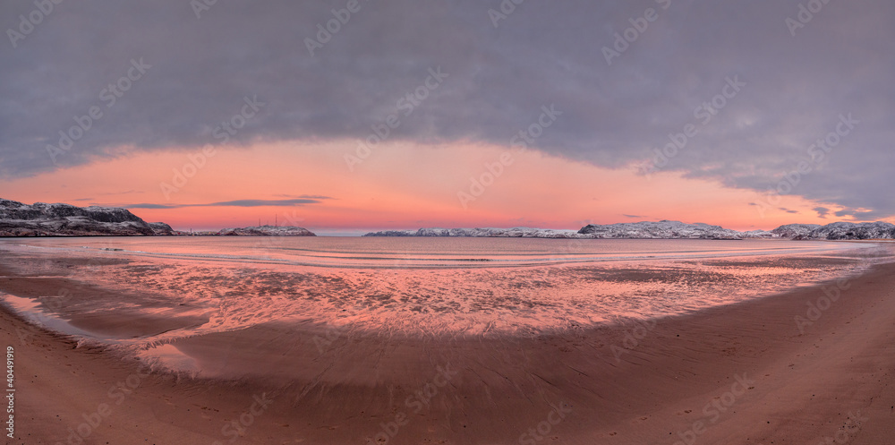 Wide panoramic view of winter sunset with amazing magenta color over fjord.
