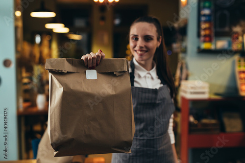 woman waitress holding take away food in restaurant photo