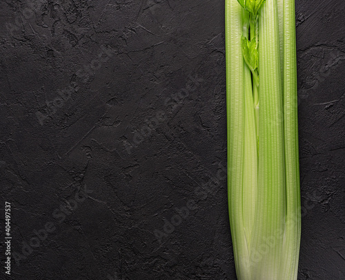 bunch of green celery  on black background.Macro food photography.Top view with copy space.