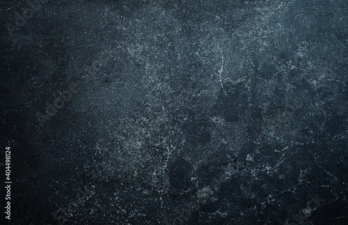 Grunge dark grey stone wall background.