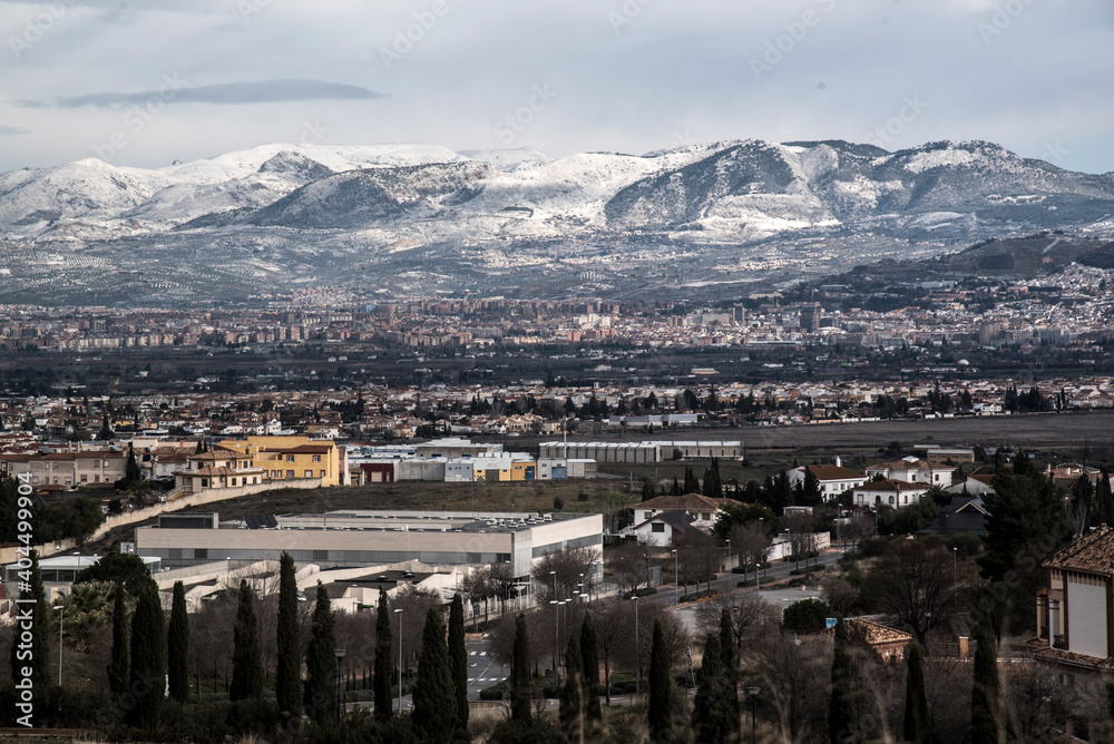 landscape with snowy mountains and Granada city line