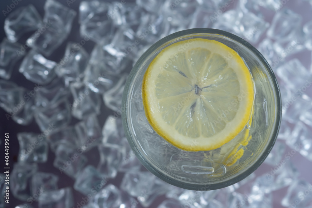 Glass with beverage with lemon and ice. Top view Glass with beverage with lemon and ice. Top view