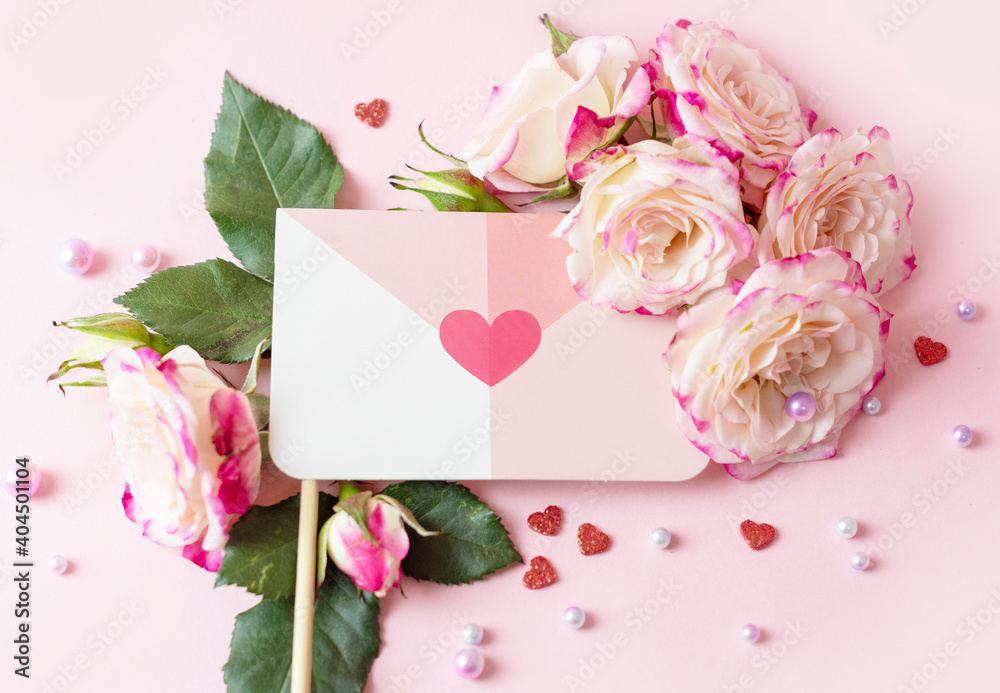 envelope, valentine's letter and delicate bouquet of bushy peony roses and pearls on a pink background, the concept of congratulations on Valentine's day